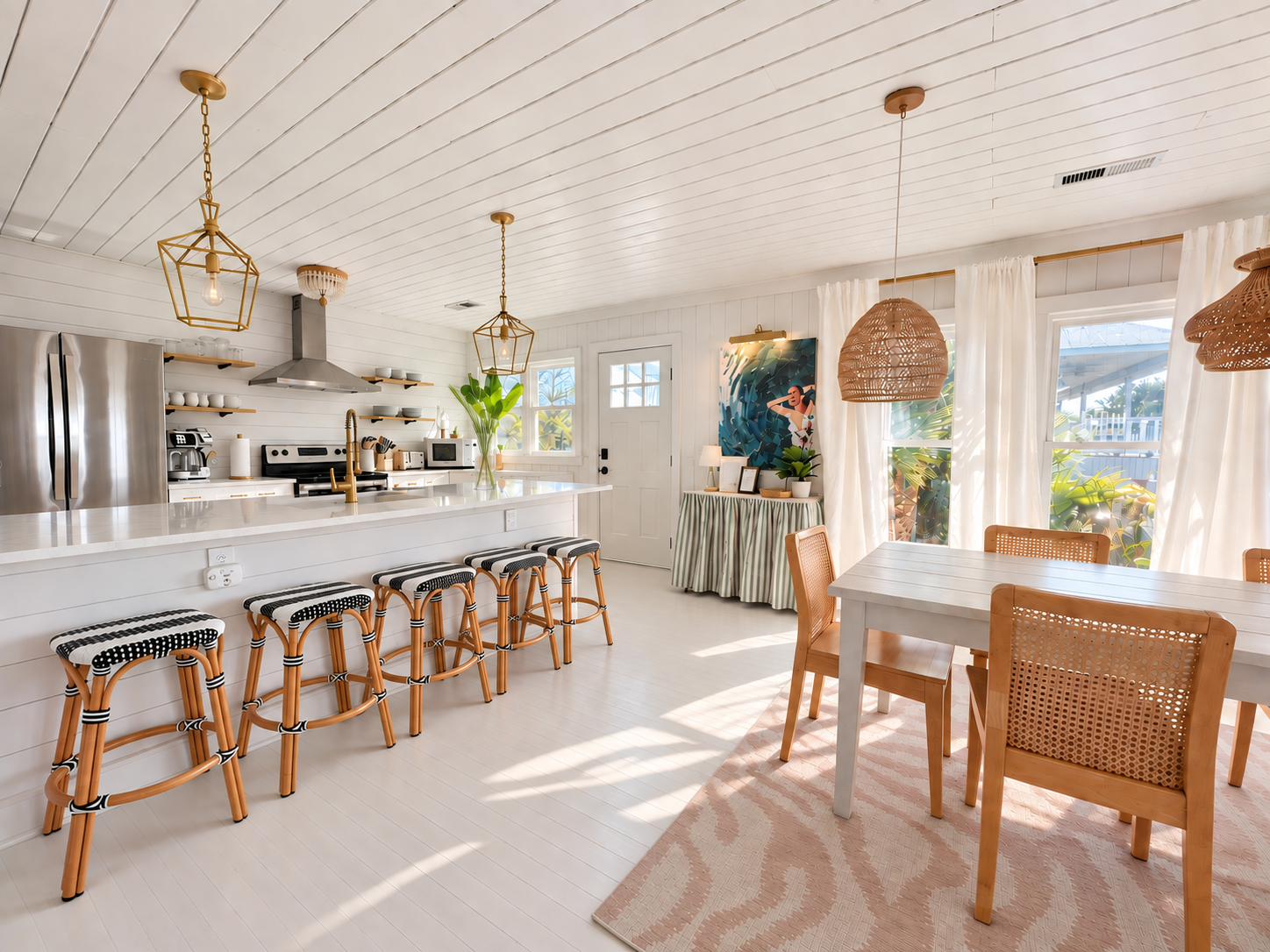 Blue Anchor dining area with white shiplap, brass pendant lights, and rattan chairs